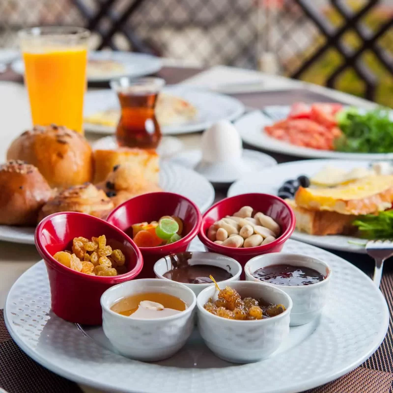 Food-Items-with-nuts-dried-fruit-honey-orange-juice-tea-side-view